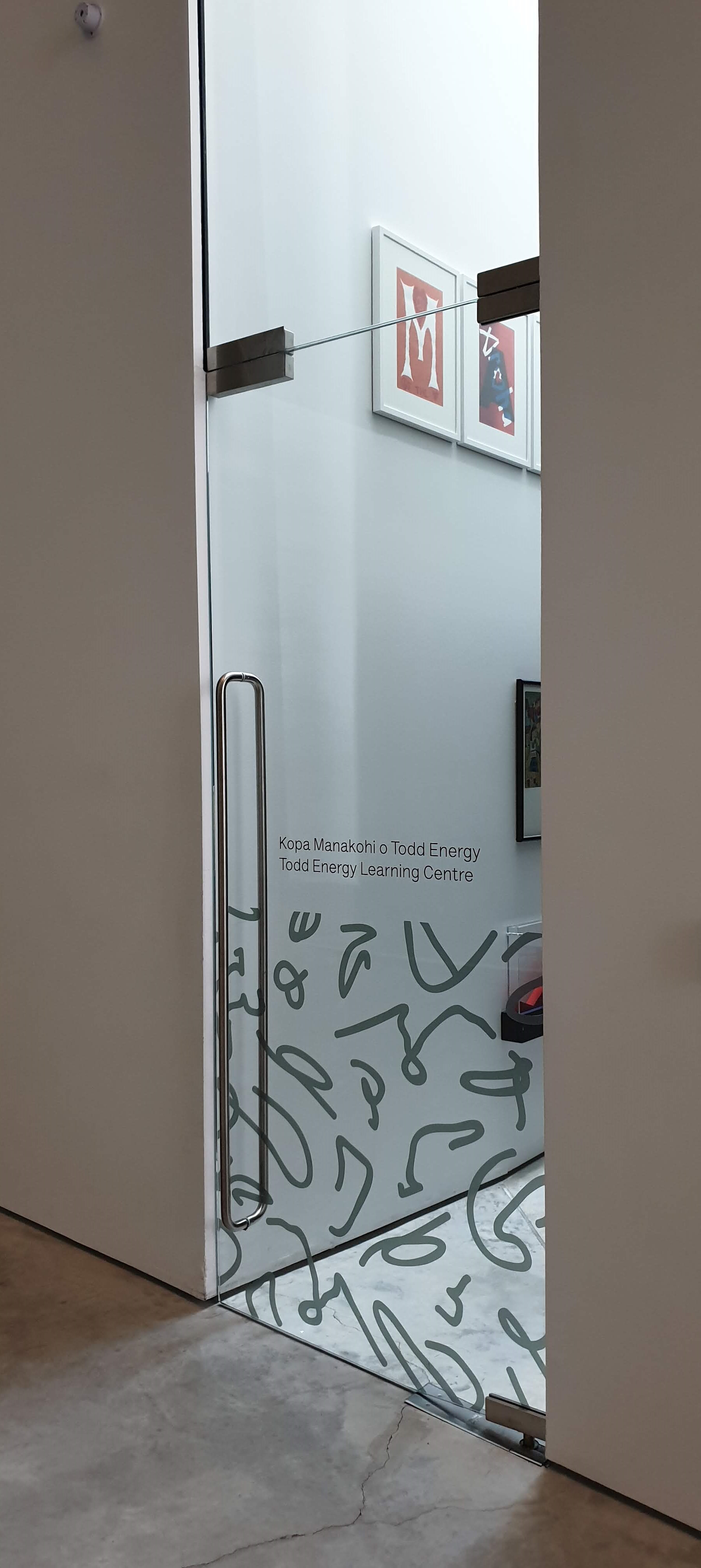Aesthetic access added to a glass door in an art gallery