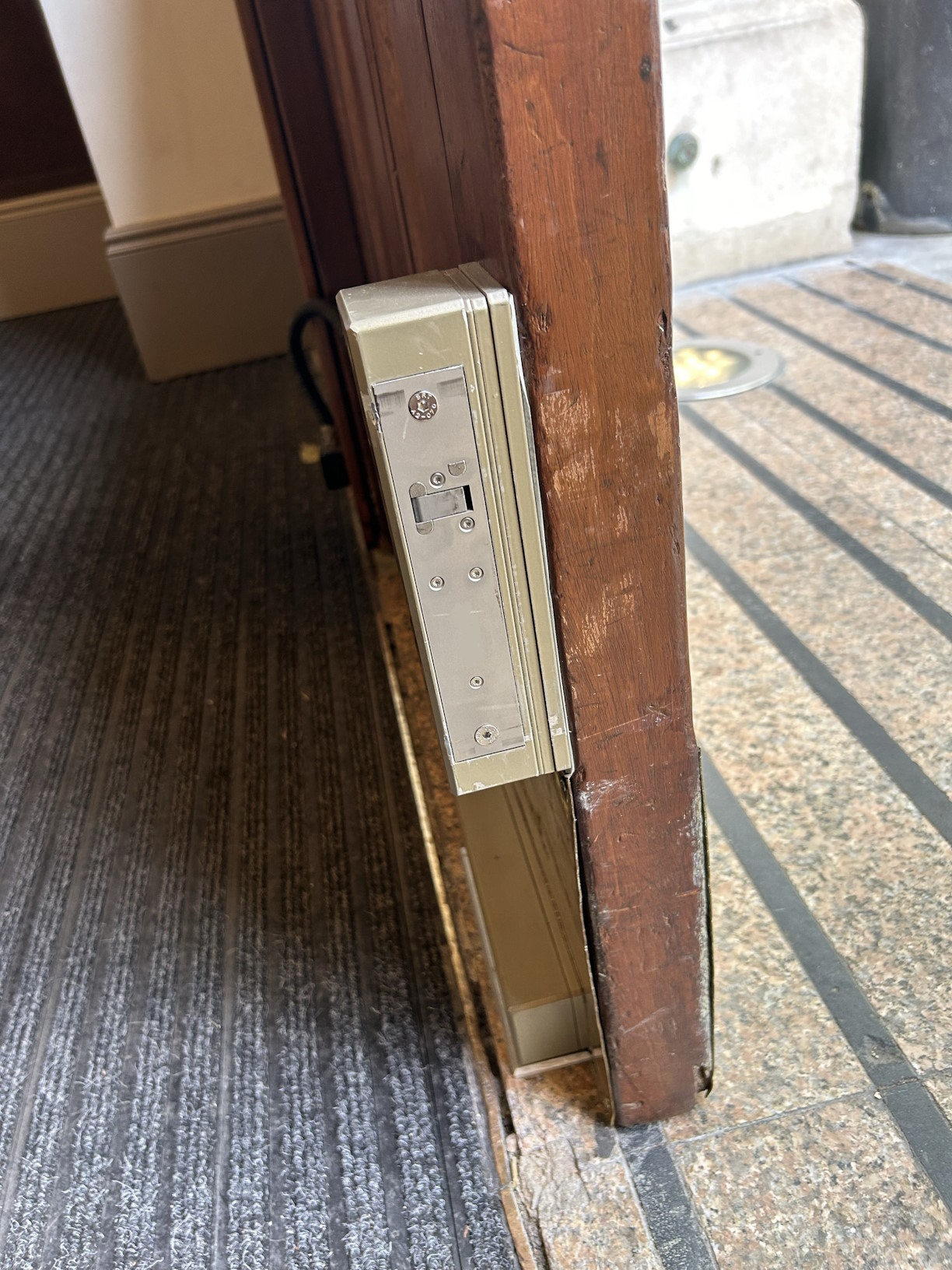 A surface mount solution was required to secure the entrance door of a public building