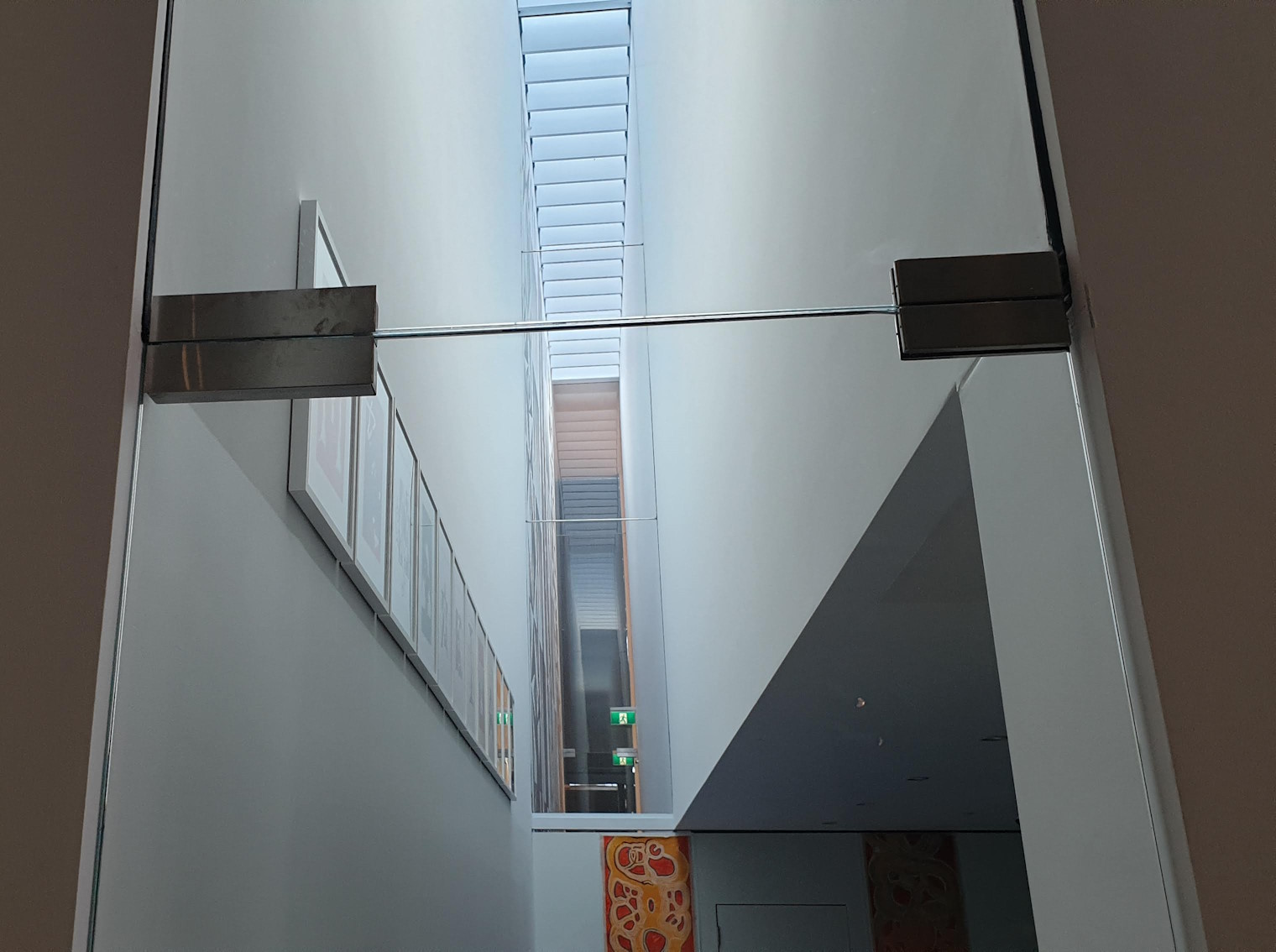 Surface mounted lock and housing on glass door and header